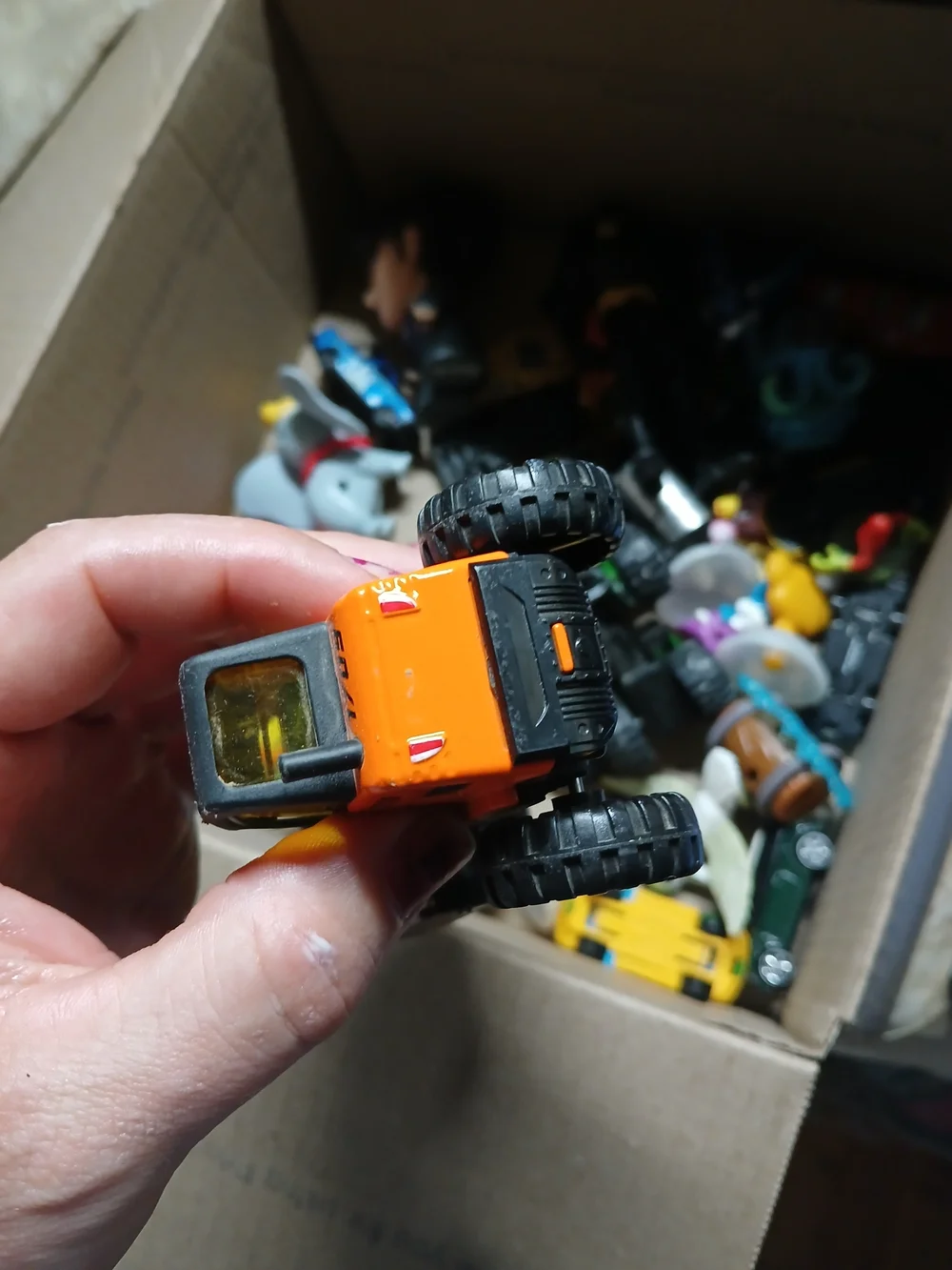 die-cast orange road roller toy Maisto